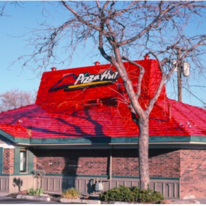 pizza hut exterior with red tiled roof and tree shadows