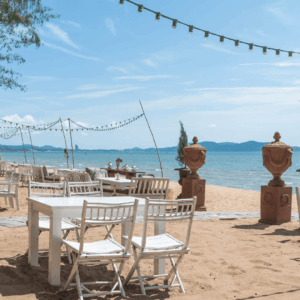 terraza de playa con mesas blancas y luces