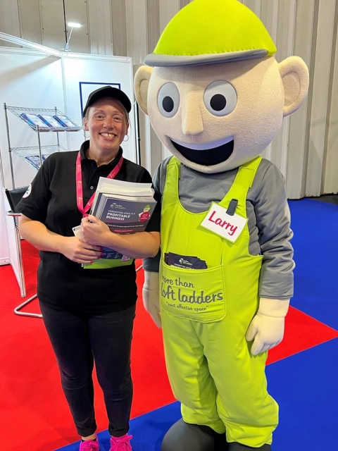 woman with larry mascot at trade show booth