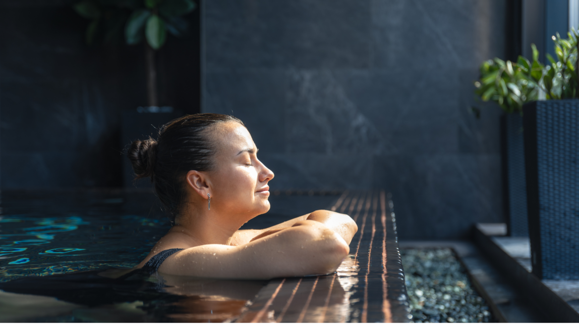 sunlit woman resting at indoor pool