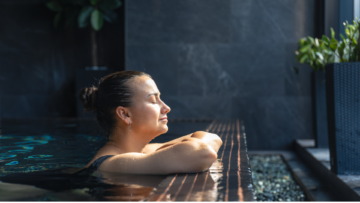 sunlit woman resting at indoor pool