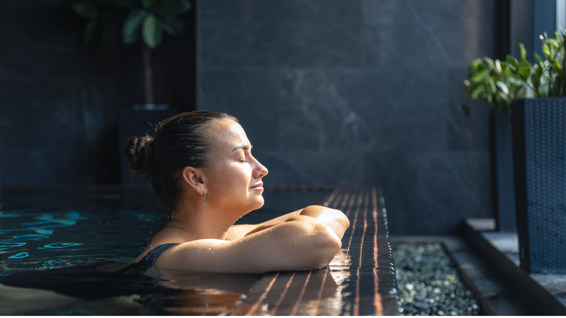 sunlit woman resting at indoor pool