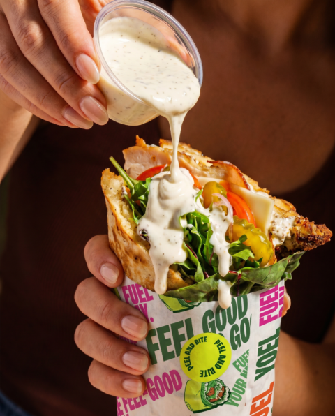 creamy pepper dressing drizzling over chicken wrap