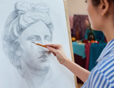 artists hand sketching greco roman bust
