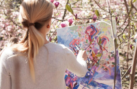 plein air painter among magnolia blossoms