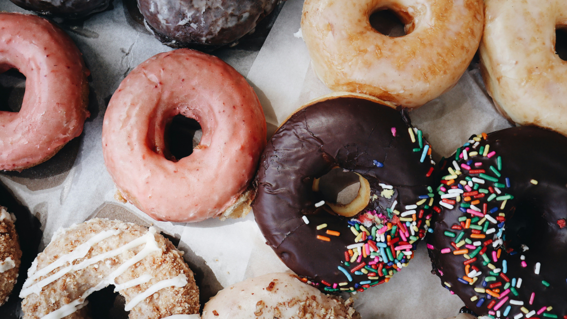 assorted donuts with chocolate and sprinkle glaze