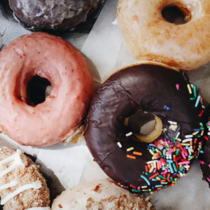 assorted donuts with chocolate and sprinkle glaze