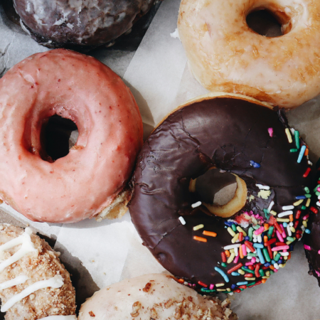 assorted donuts with chocolate and sprinkle glaze