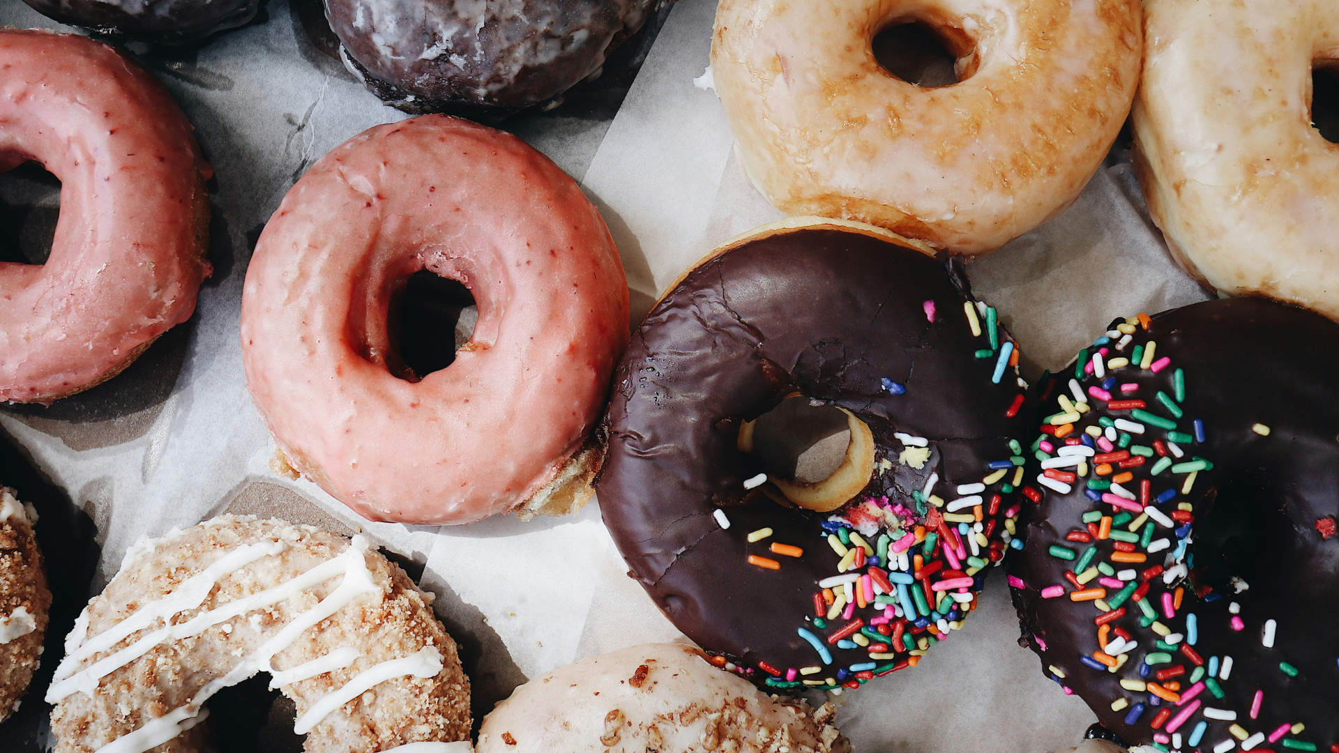 assorted donuts with chocolate and sprinkle glaze