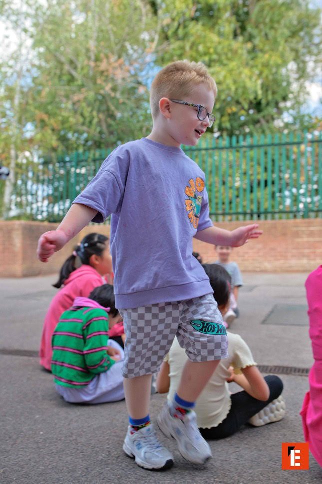 boy in glasses playing outdoors