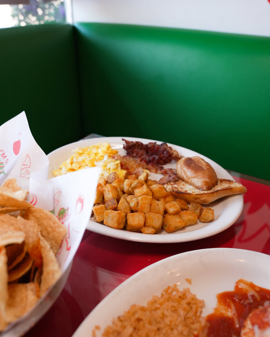 hearty breakfast plate with potatoes, eggs and bacon