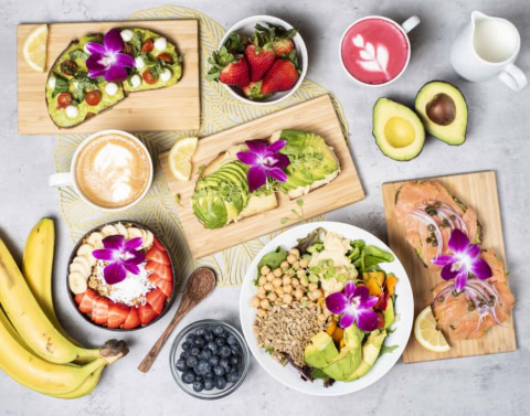 colorful brunch spread with avocado toast and fruit