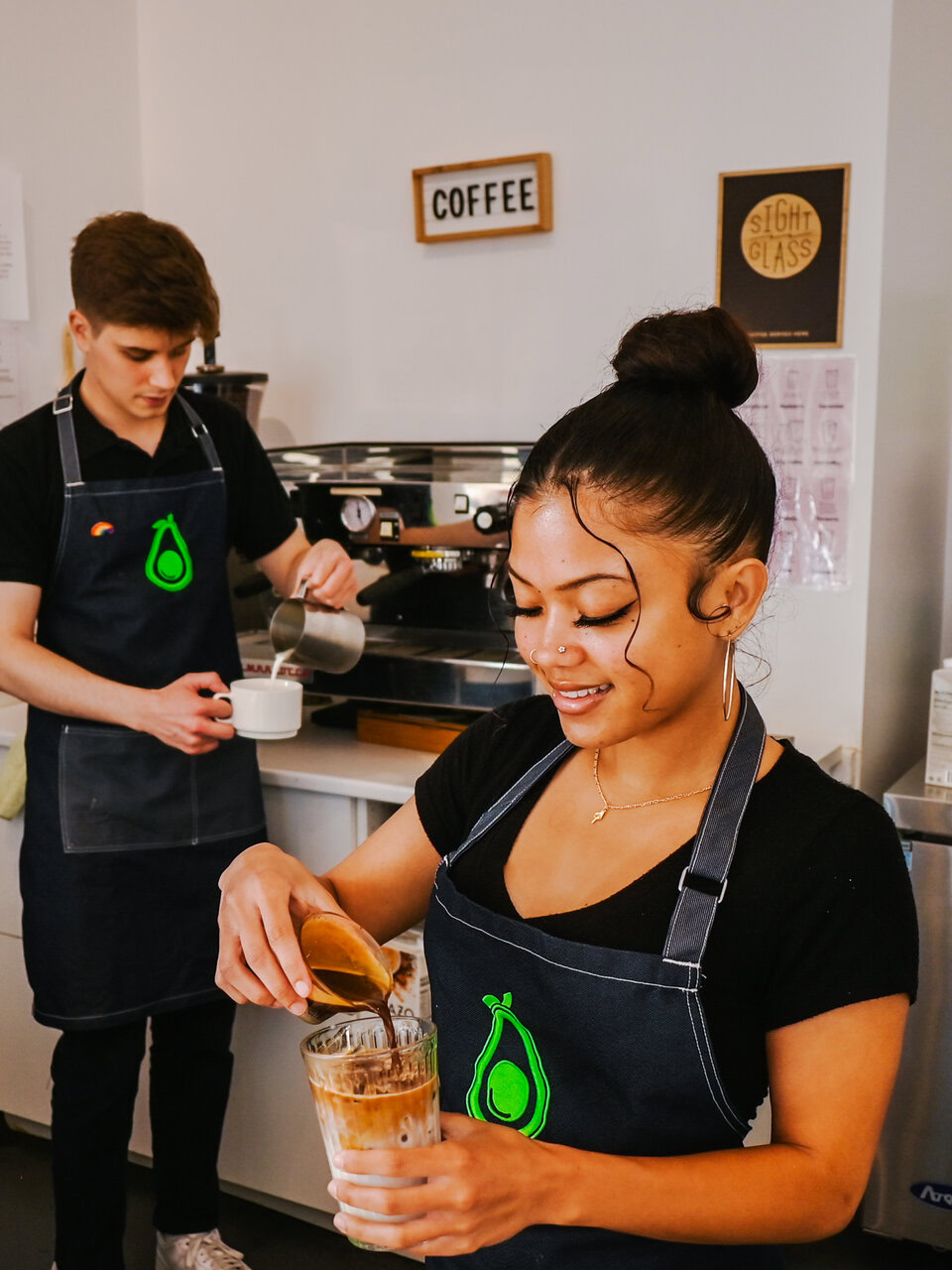 coffee shop baristas preparing espresso drinks