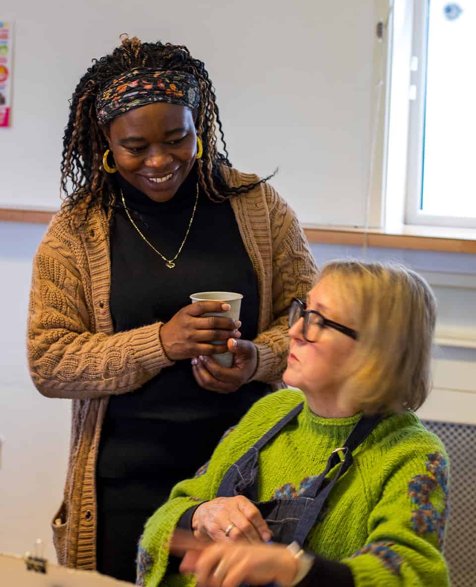 cosy community conversation between women in knitwear