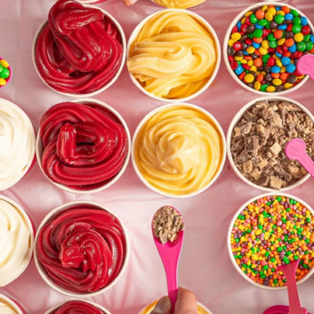 colorful dessert topping station with pink spoons