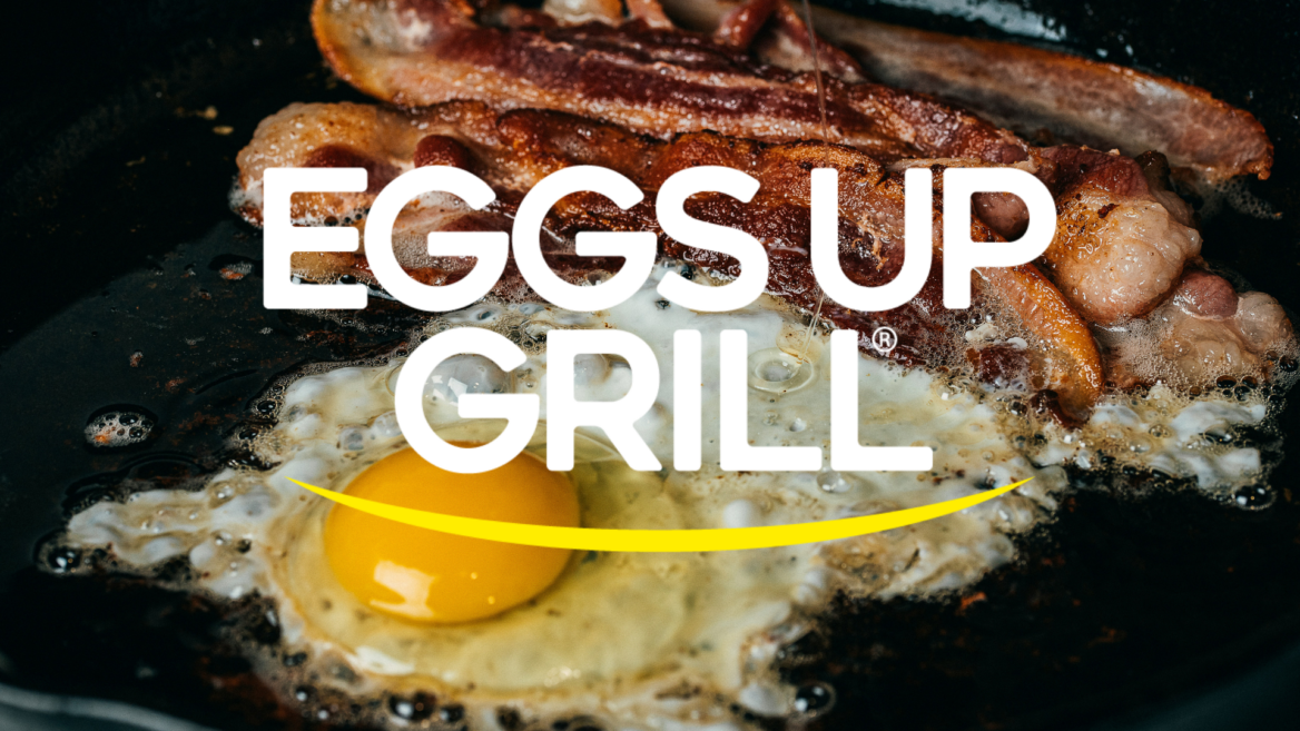 sizzling egg with runny yolk and crispy bacon