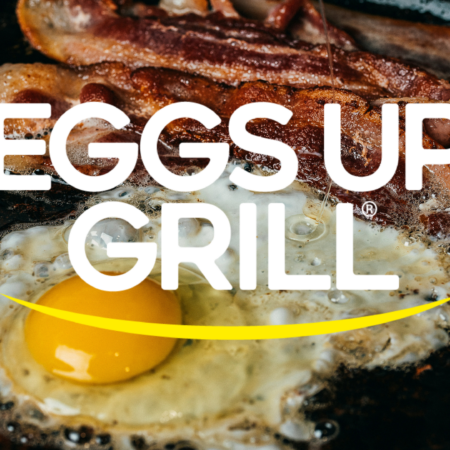 sizzling egg with runny yolk and crispy bacon