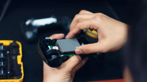 hands inspecting open circuit board repair