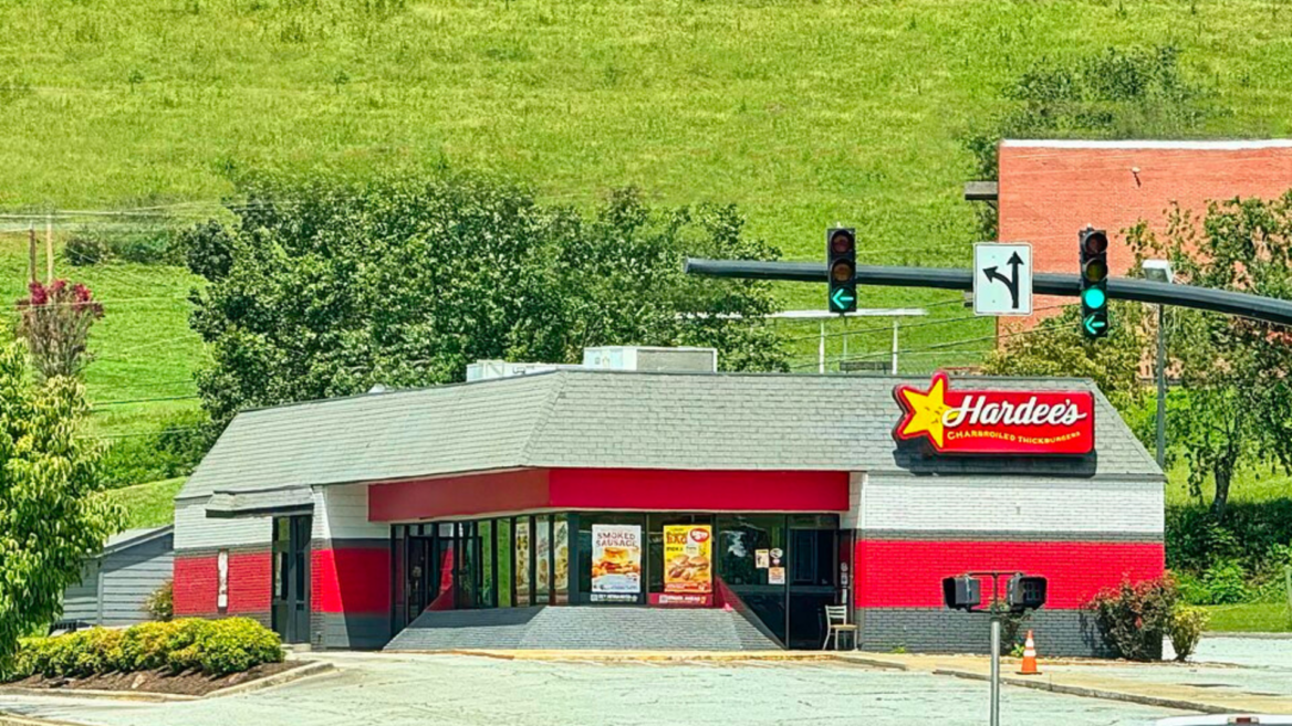red hardees restaurant at sunny suburban intersection