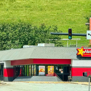 red hardees restaurant at sunny suburban intersection