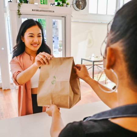 friendly café pickup handoff at counter