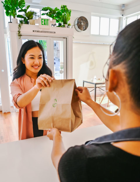 friendly café pickup handoff at counter