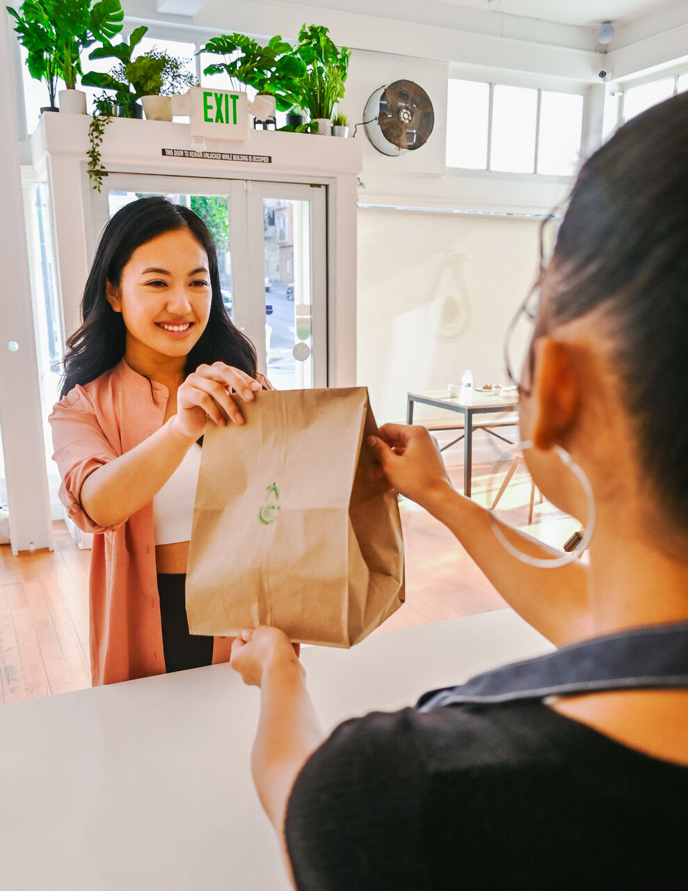 friendly café pickup handoff at counter
