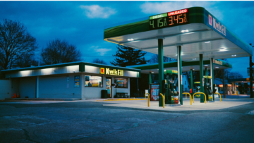 twilight gas station with empty lit canopy