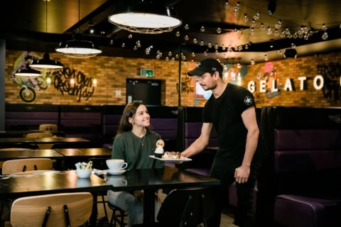 cosy gelato cafe serving dessert under string lights