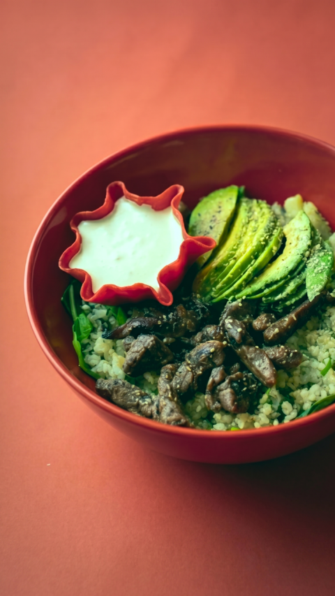 elegant grain bowl with avocado and sesame beef