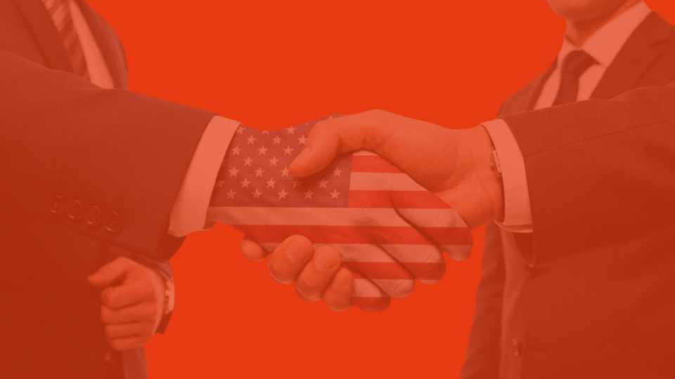 american business handshake with flag overlay
