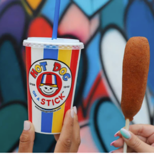 colorful corn dogs with hot dog on a stick cup