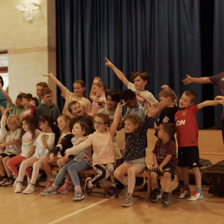 kids and teachers celebrating on school stage