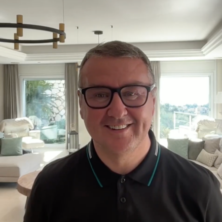 smiling man with glasses in bright modern living room
