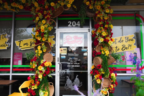 festive restaurant entrance with floral anniversary display
