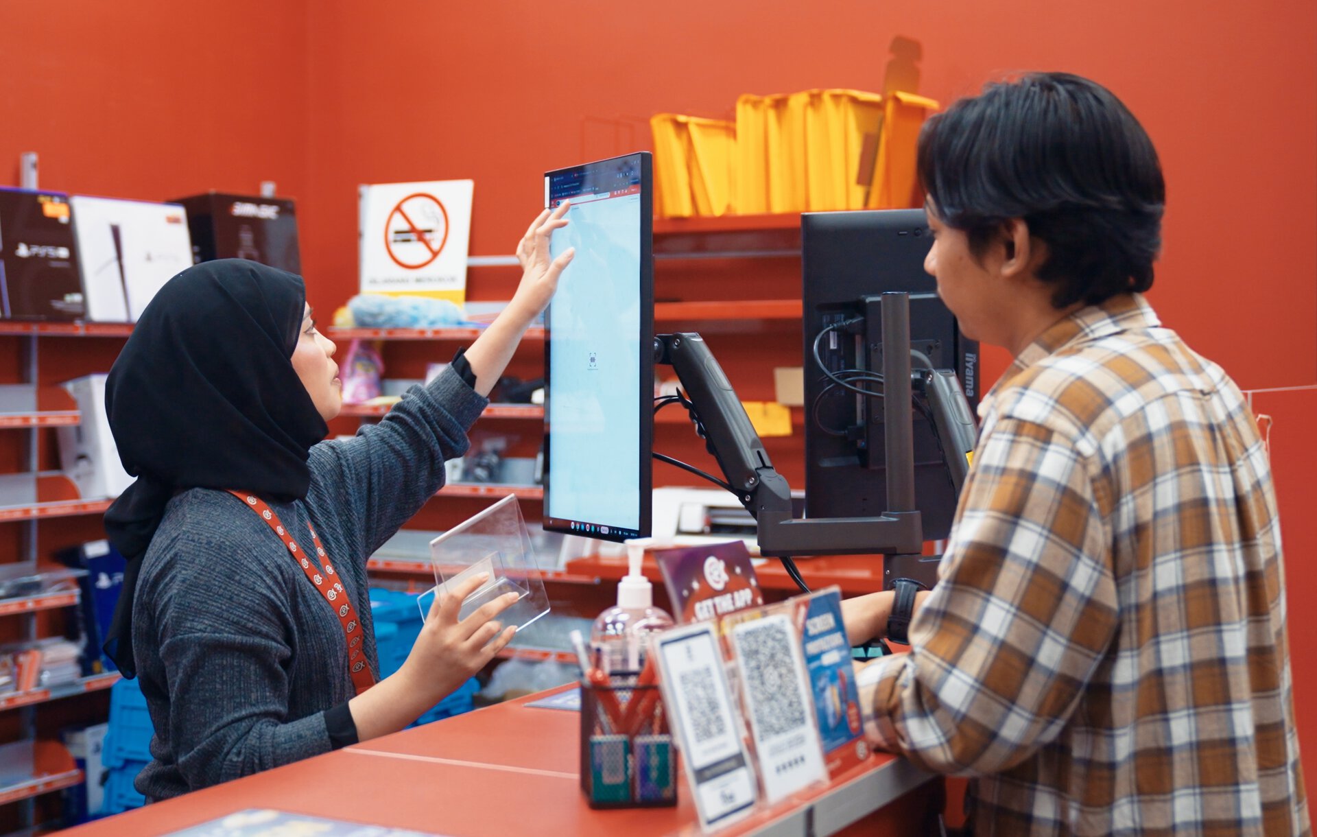 woman using touchscreen at electronics checkout