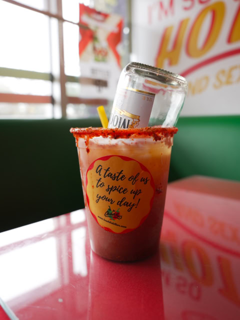 spicy red cocktail in a branded cup