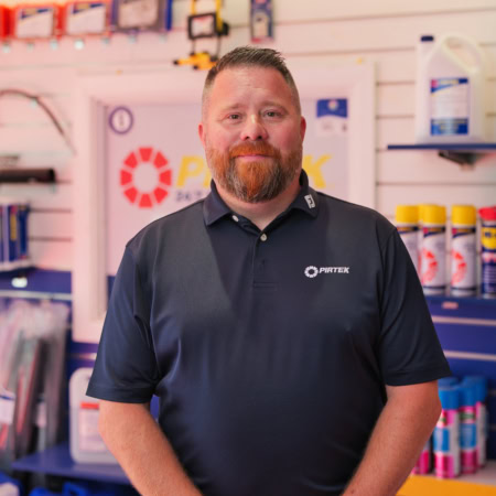 friendly pirtek technician portrait at service counter
