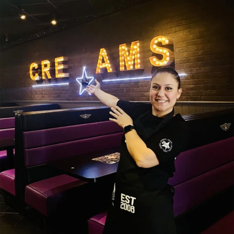 smiling server at neon ice cream parlour