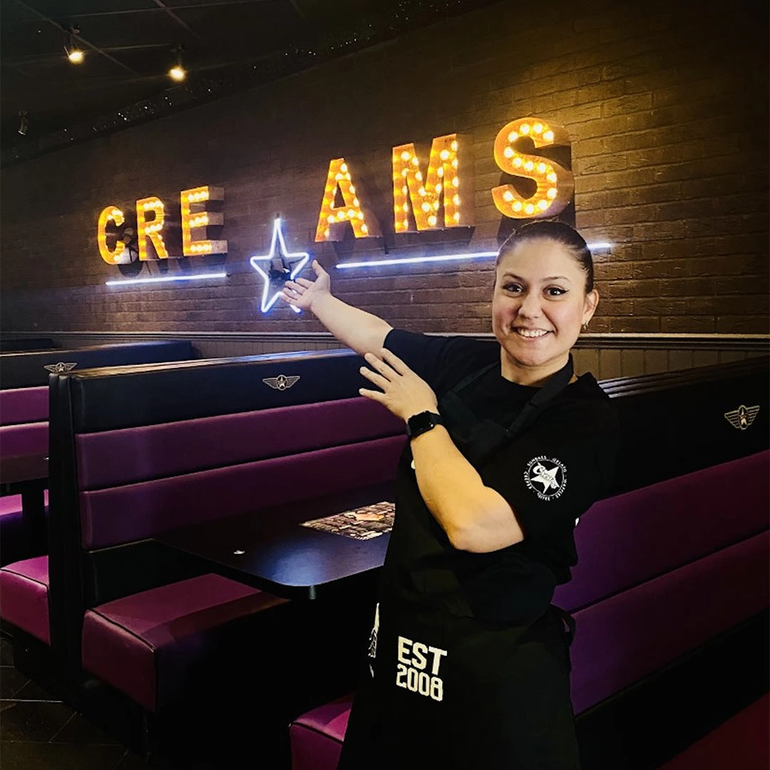 smiling server at neon ice cream parlour