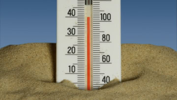 termometro nella sabbia: caldo estivo in spiaggia