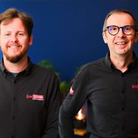 two professionals smiling in blue team portrait