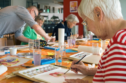 watercolour workshop: focused senior artist at table