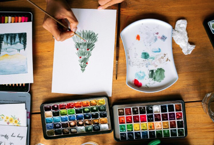 watercolour evergreen painting in cosy workspace