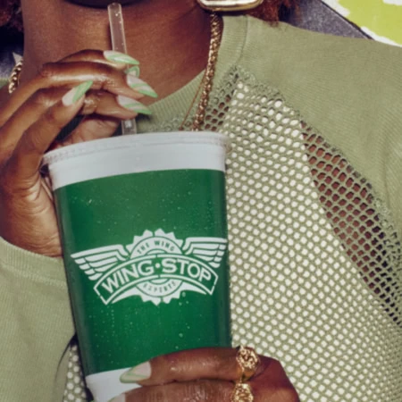 mains ornées tenant gobelet vert wingstop