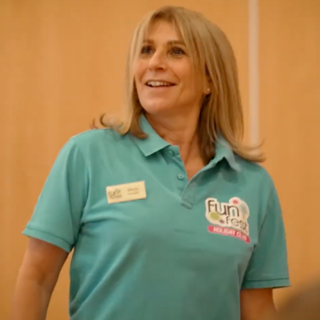 smiling activity leader in teal polo