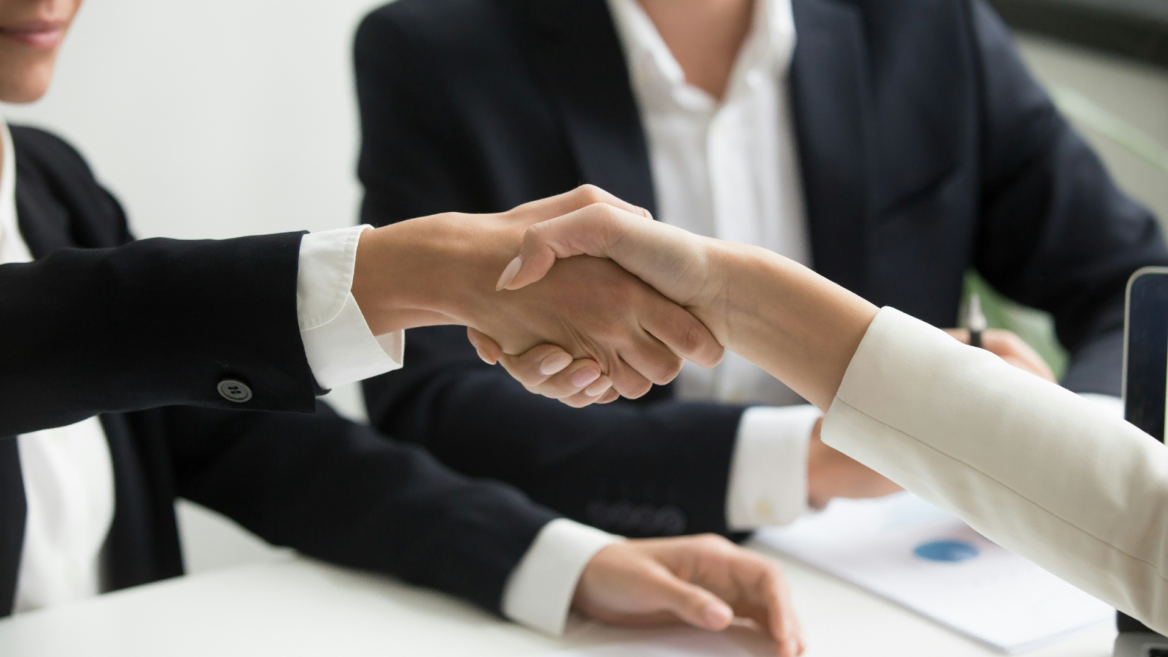 business handshake in a corporate meeting
