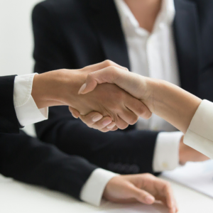 business handshake in a corporate meeting