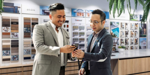 businessmen reviewing design options on smartphone