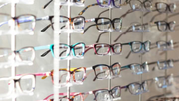 présentoir de lunettes colorées en boutique optique